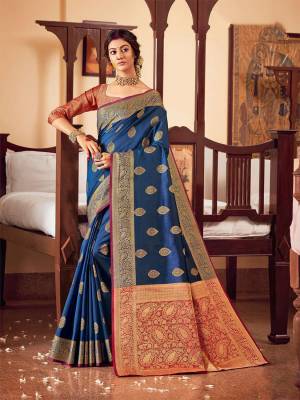Adorn A Proper Traditional Look Wearing This Heavy Weaved Designer saree In Blue Color Paired With Magenta Pink Colored Blouse. This Saree and Blouse Are Fabricated On Handloom Silk Which Also Gives A Rich Look To Your Personality. 