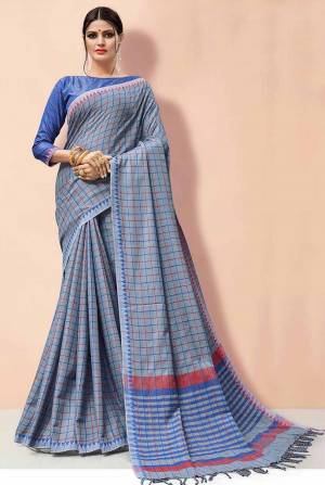 Flaunt Your Rich And Elegant Taste Wearing This Linen Based Rich Saree In Grey Color Paired With Blue Colored Blouse. This Saree And Blouse Are Fabricated On Linen Beautified With Prints, So It Is Light In Weight And Easy To Carry All Day Long. 