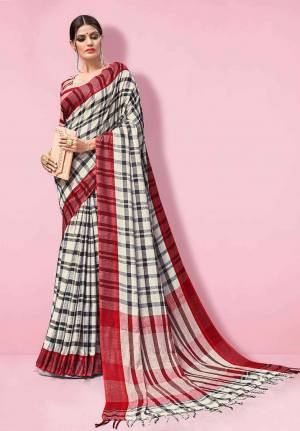 Flaunt Your Rich And Elegant Taste Wearing This Linen Based Rich Saree In White and Black Color Paired With Maroon Colored Blouse. This Saree And Blouse Are Fabricated On Linen Beautified With Prints, So It Is Light In Weight And Easy To Carry All Day Long. 