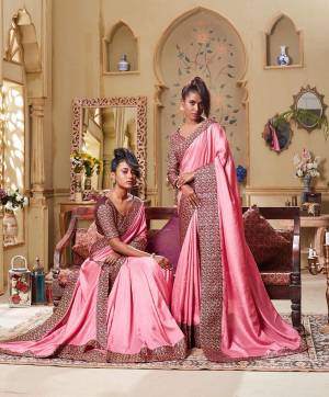 Flaunt Your Rich Taste Wearing This Elegant Looking Saree In Pink Color Paired With Wine Colored blouse. This Saree Is Rich Based Beautified With Broad Attractive Border. It Is Light In Weight And Easy To Carry All Day Long. 