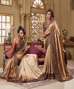 Flaunt Your Rich Taste Wearing This Elegant Looking Saree In Beige Color Paired With Brown Colored blouse. This Saree Is Rich Based Beautified With Broad Attractive Border. It Is Light In Weight And Easy To Carry All Day Long. 