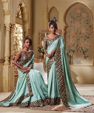Flaunt Your Rich Taste Wearing This Elegant Looking Saree In Baby Blue Color Paired With Grey Colored blouse. This Saree Is Rich Based Beautified With Broad Attractive Border. It Is Light In Weight And Easy To Carry All Day Long. 