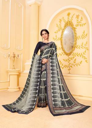 Get Ready For The Upcoming Winters With This Lovely Saree In Black And Grey Color. This Saree And Blouse Are Fabricated On Pashmina Beautified With Prints All Over. Its Rich Fabric and Color Will Earn You Lots Of Compliments From Onlookers. 