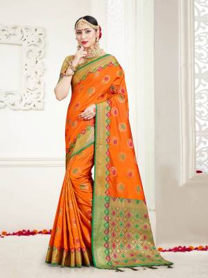 Here Is A Proper Traditional Looking Designer Silk Based saree In?Orange Color Paired With Golden Colored Blouse. This Saree and Blouse Are Fabricated On Banarasi Art Silk Beautified With Attractive Weave.