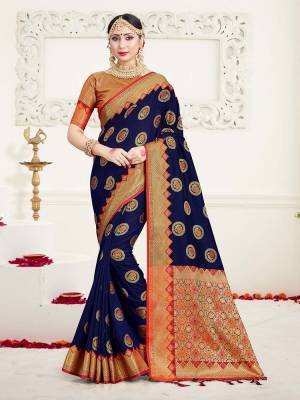Here Is A Proper Traditional Looking Designer Silk Based saree In?Navy Blue Color Paired With Golden Colored Blouse. This Saree and Blouse Are Fabricated On Banarasi Art Silk Beautified With Attractive Weave.