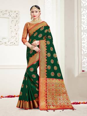 Look Beautiful Wearing This Rich Designer Saree In Dark Green Color Paired With Golden Colored Blouse. This Saree And Blouse Are Fabricated On Banarasi Art Silk Beautified With Weave. Buy Now