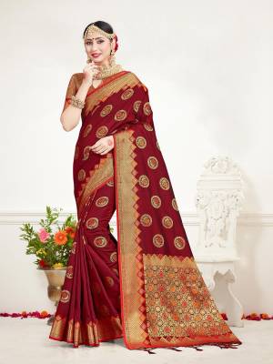 Here Is A Proper Traditional Looking Designer Silk Based saree In?Maroon Color Paired With Golden Colored Blouse. This Saree and Blouse Are Fabricated On Banarasi Art Silk Beautified With Attractive Weave.