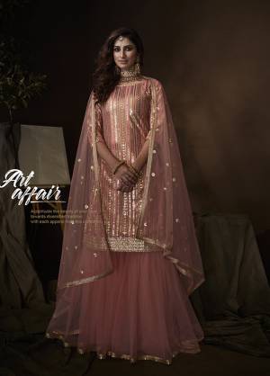 Get Ready For The Upcoming Wedding And Festive Season Wearing this Heavy Designer Sharara Suit In All Over Peach Color. Its Lovely Top, Bottom And Dupatta Are Fabricated On Net Beautified With Attractive Embroidery. 