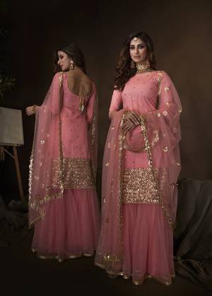 Get Ready For The Upcoming Wedding And Festive Season Wearing this Heavy Designer Sharara Suit In All Over Pink Color. Its Lovely Top, Bottom And Dupatta Are Fabricated On Net Beautified With Attractive Embroidery. 