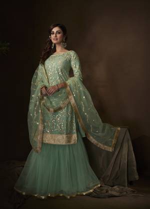Shine Bright Wearing This Lovely Designer Sharara Suit In All Over Sea Green Color. Its Top, Bottom And Dupatta Are Fabricated On Net Beautified With Attractive Embroidery Work. Buy This Pretty Suit Now.
