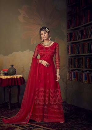 Grab This Very Beautiful Heavy Designer Sharara Suit In Red Color. Its Pretty Embroidered Top, Bottom And Dupatta Are Fabricated On Net Beautified With Tone To Tone Embroidery Giving A Heavy Yet Subtle Look. Its Top Is Semi-Stitched With Fully Stitched Sharara. 