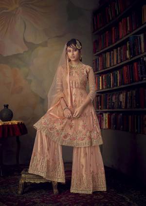 Grab This Very Beautiful Heavy Designer Sharara Suit In Peach Color. Its Pretty Embroidered Top, Bottom And Dupatta Are Fabricated On Net Beautified With Tone To Tone Embroidery Giving A Heavy Yet Subtle Look. Its Top Is Semi-Stitched With Fully Stitched Sharara. 