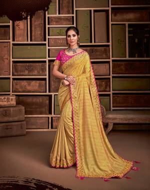 For a traditional diva-like look, this mustard yellow jacquard saree  color combined with a vibrant shade of pink and floral embroidery is an apt pick. Pair it with a pretty choker necklace to uplift the look. 