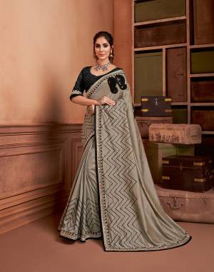 The secret of looking sophisticated and charming is to adorn in an attire that spells your personality beautifully. This chevron embroidered greyish saree paired with black blouse is simple, subtle and fits well with women of any personality. 