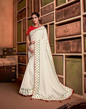 Define the best on indian culture in this classic combination of white and red saree infused with just the right amount of green hue. Style it with bold jewelry or go subtle with dainty ones, this design is at its versatile best. 