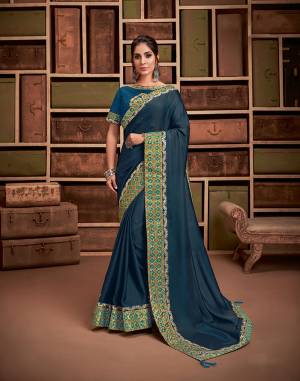Be an epitome of grace and rich taste in fashion in this very simple yet  outstanding teal blue saree contrasted with printed silk borrder and delicate embroidery. 