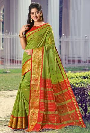 Simple And Elegant Looking Silk Based saree Is Here In Green Color Paired With Red Colored Blouse. This Saree and Blouse Are Fabricated On Handloom Silk Beautified With Weave All Over. Buy Now.