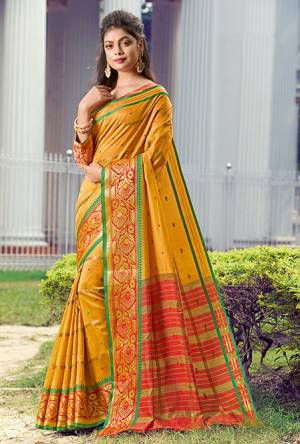 Celebrate This Festive Season Wearing This Pretty Saree In Musturd Yellow Color Paired With Orange Colored Blouse. This Saree And Blouse Are Fabricated On Handloom Silk Beautified With Weave. 