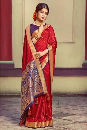 Here Is A Pretty Silk Based Saree In Red Colored Paired With Contrasting Purple colored Blouse. This Saree and Blouse Are Fabricated On Handloom Silk Beautified With Weave All Over. It Is Light In Weight And Easy To Carry All Day Long. 