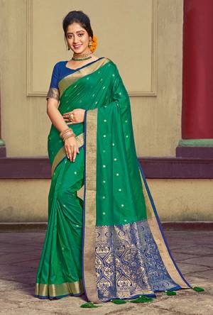 Here Is A Pretty Silk Based Saree In Green Colored Paired With Contrasting Royal Blue colored Blouse. This Saree and Blouse Are Fabricated On Handloom Silk Beautified With Weave All Over. It Is Light In Weight And Easy To Carry All Day Long. 