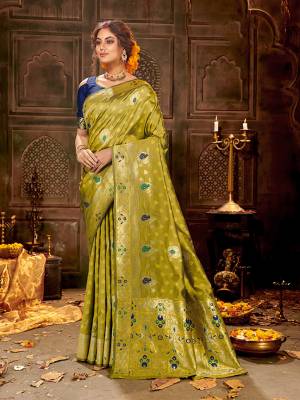 Flaunt Your Rich And Elegant Taste Wearing Thi Silk Based saree Is Here In Olive Green And Royal Blue Color. This Saree and Blouse Are Fabricated On Banarasi Art Silk Beautified With Weave All Over. Buy Now.