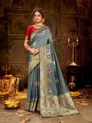 Flaunt Your Rich And Elegant Taste Wearing Thi Silk Based saree Is Here In Grey And Red Color. This Saree and Blouse Are Fabricated On Banarasi Art Silk Beautified With Weave All Over. Buy Now.