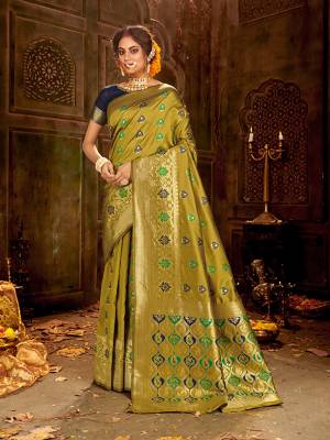 Flaunt Your Rich And Elegant Taste Wearing Thi Silk Based saree Is Here In Olive Green And Navy Blue Color. This Saree and Blouse Are Fabricated On Banarasi Art Silk Beautified With Weave All Over. Buy Now.