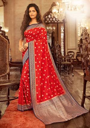 Celebrate This Festive Season Wearing This Pretty Designer Silk Based Saree In Red Color Paired With Navy Blue Colored Blouse. This Saree And Blouse Are Fabricated On Chanderi Cotton Beautified With Weave All Over. 
