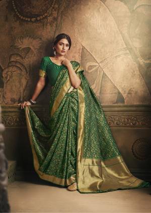 Here Is A Royal Looking Rich Designer Saree In Dark Green Color. This Saree And Blouse Are Fabricated On Banarasi Art Silk Beautified With Detailed Weave. Its Rich Fabric And Color Gives An elegant Look And Will Definitely Earn You Lots Of Compliments From Onlookers. 