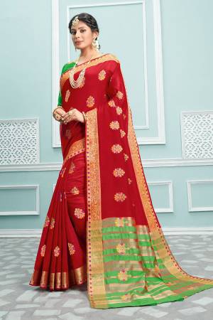 Celebrate This Festive Season Wearing This Designer Saree In Red Color Paired With Contrasting Green Colored Blouse. This Saree and Blouse Are Fabricated On Cotton Beautified With Weave. Buy This Pretty Saree Now.