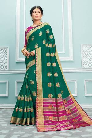Here Is A Pretty Designer Saree In Sea Green Color Paired With Magenta Pink Colored Blouse. This Saree And Blouse Are Fabricated On Cotton Beautified With Weaved Motifs And Broad Border. 