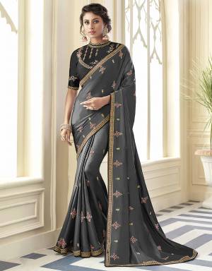 For A Bold And Beautiful Look, Grab This Designer Saree In Grey Color Paired With Black Colored Blouse. This Saree Is Fabricated Satin Silk Paired With Art Silk Fabricated Blouse. Its  Fabric And Color Will Gives A Rich And Elegant Look To Your Personality. 