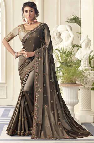 Flaunt Your Rich And Elegant Taste Wearing This Very Beautiful Designer Embroidered saree In Brown Color Paired With Light Beige Colored blouse. This Saree Is Satin Silk Based Paired with Art Silk Fabricated Blouse. Buy Now.